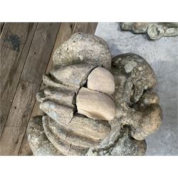 Four grotesque garden wall masks