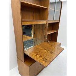 G-Plan three sectional wall unit, fitted with shelving enclosed by glazed shelving, fall front opening, based unit fitted with cupboard doors enclosing shelving, raised on plinth base 