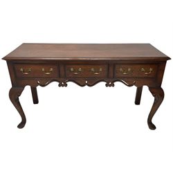 Georgian design oak and mahogany dresser base, the rectangular moulded top with mahogany band, three cocked-beaded and banded drawers over shaped a pierced apron, circular brass handle plates and swan neck handles, on C-scroll carved cabriole supports 