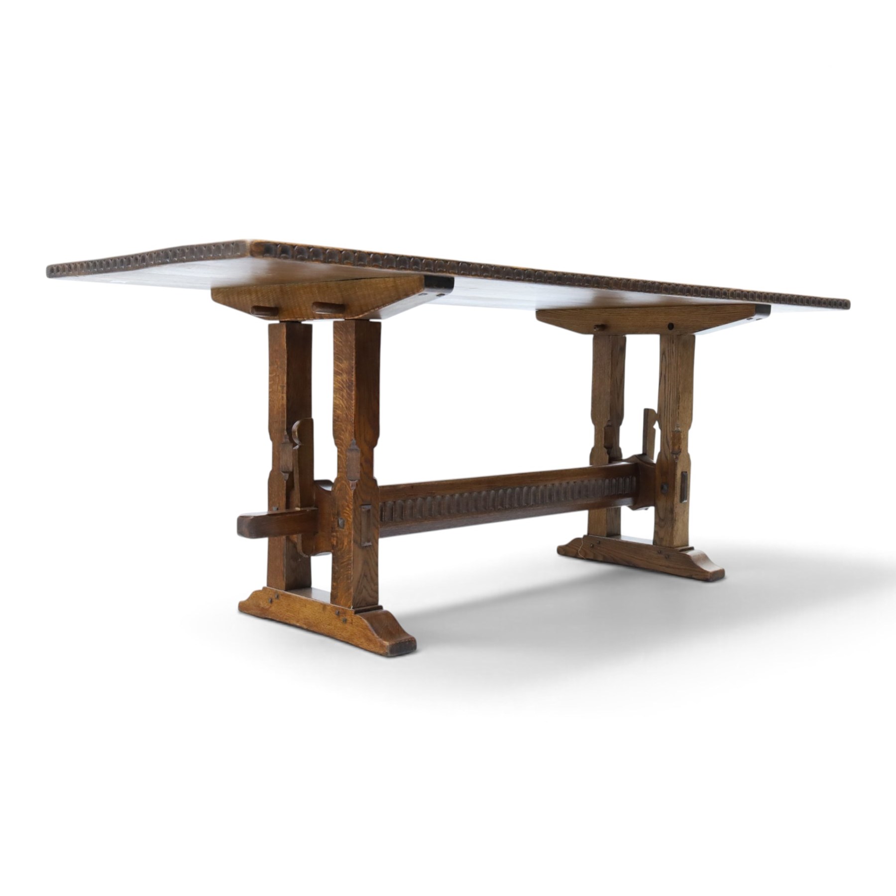 Rupert Griffiths for Monastic Woodcraft - oak 6ft refectory dining table with set six (4+2) matching chairs, rectangular top with arcaded frieze, with trestle base with further arcaded carved stretchers, chairs with carved rails and finials, leather wrapped seats with stud detail, turned supports united by carved stretcher