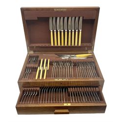 Elkington & Co part canteen of silver plated and stainless steel cutlery, to include simulated ivory handled examples, housed in oak and mahogany case, lock plate stamped 'Acme, British Made', W49cm D31cm H18cm
