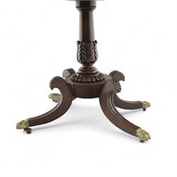 Regency rosewood fold over card table, the rectangular top with rounded corners and gadrooned edge opening to reveal a green baize lined interior, raised upon convex lobbed and acanthus pedestal and four fluted sabre legs, terminating in brass lion paw feet and castors
