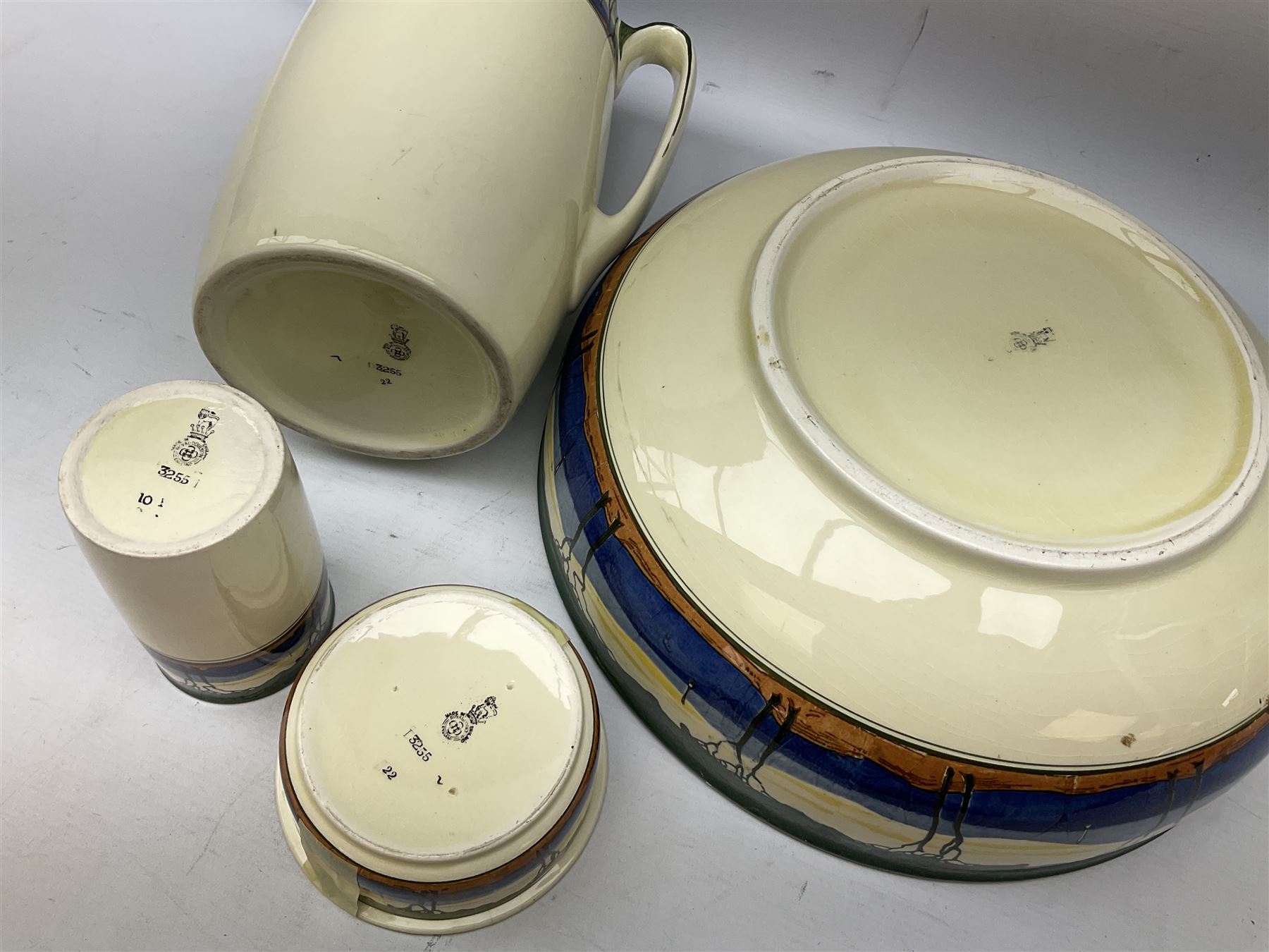 1930's Art Deco Royal Doulton ceramics decorated with stylised trees, comprising washbowl and jug, soap dish and vase