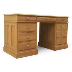 Solid pine twin pedestal desk, fitted with nine drawers, fielded panelled sides