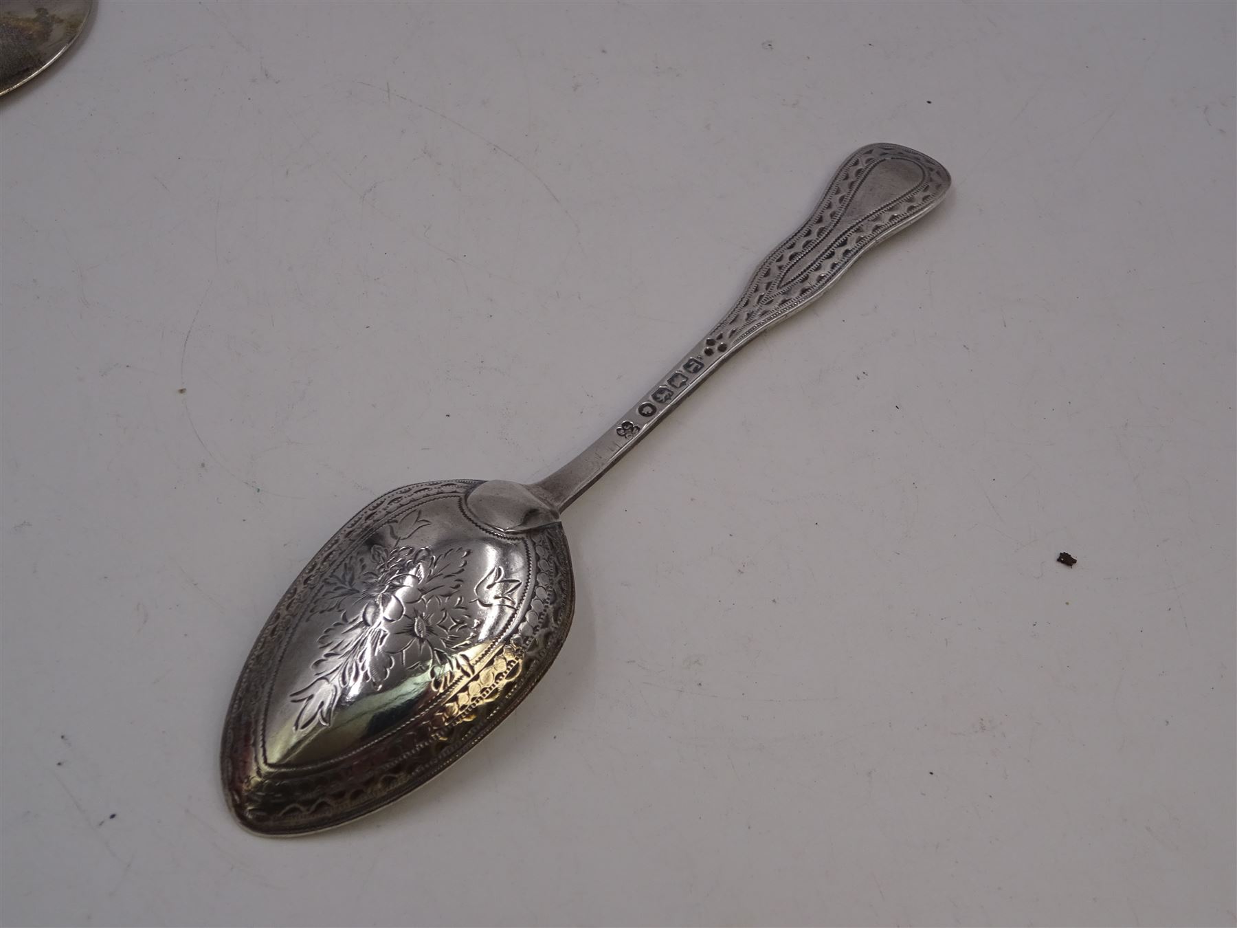 George III Exeter silver Old English pattern table spoon, engraved with foliate decoration, initials and dated 1784 to terminal, hallmarked Exeter 1783, maker's mark indistinct, together with Newcastle silver Fiddle pattern butter knife, hallmarked John Walton, Newcastle 1823, Victorian Exeter silver spoon, engraved with floral design to underside of bowl, hallmarked Josiah Williams & Co, Exeter 1875