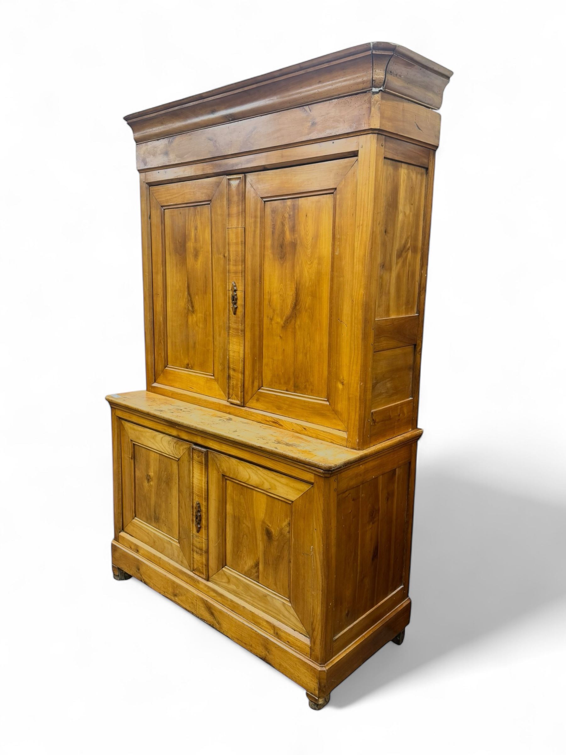 19th century French walnut dresser, the moulded cornice over two-panelled cupboard doors, enclosing two shelves and one small
drawer, on a base of two further cupboards