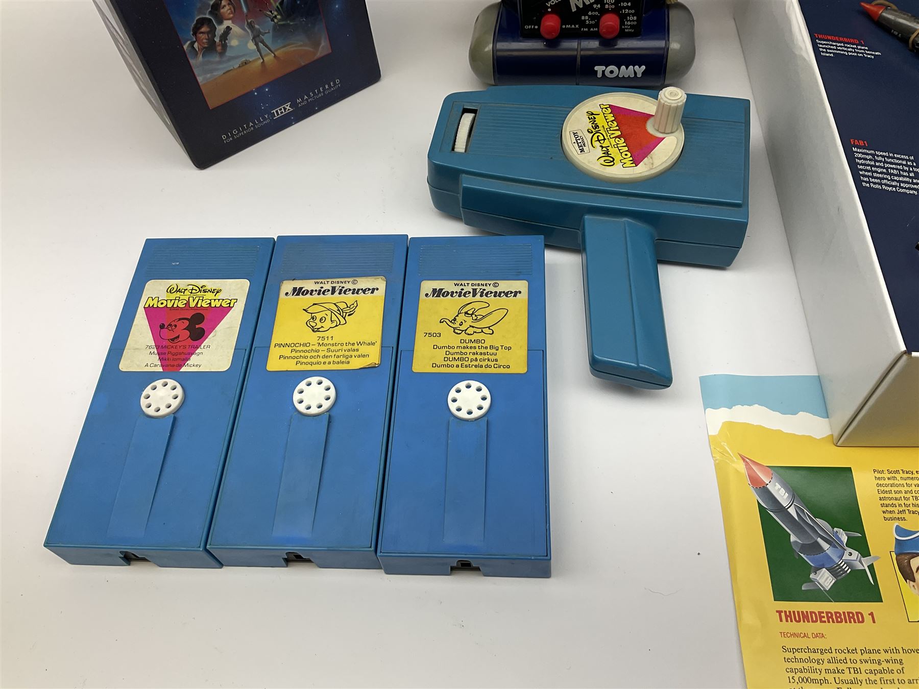 Matchbox 'The Thunderbirds' limited edition Commemorative Set, boxed with paperwork; Tomy 'Mr. D.J.' blue plastic robot radio; Mettoy Walt Disney Movie Viewer with three cassettes; and 1995 boxed set of the Star Wars trilogy VHS video tapes