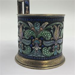 Mid 20th century Russian silver and cloisonné enamel cup, of cylindrical form upon short flared foot, the body and tall flat capped handled decorated in polychrome stylised foliage, bearing marks including right facing Kokoshnik mark with district number and mint marks for St. Petersburg, including handle H9.5cm D7cm