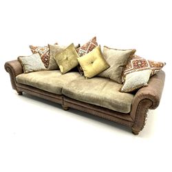 Alexander James - Grand two sectional sofa upholstered in studded leather and fabric, with contrasting kilim patterned scatter cushions, scrolling arms and turned front supports 