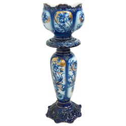Staffordshire pottery jardiniere, decorated with flowers in blue and heightened in gilt, overall H46cm 
