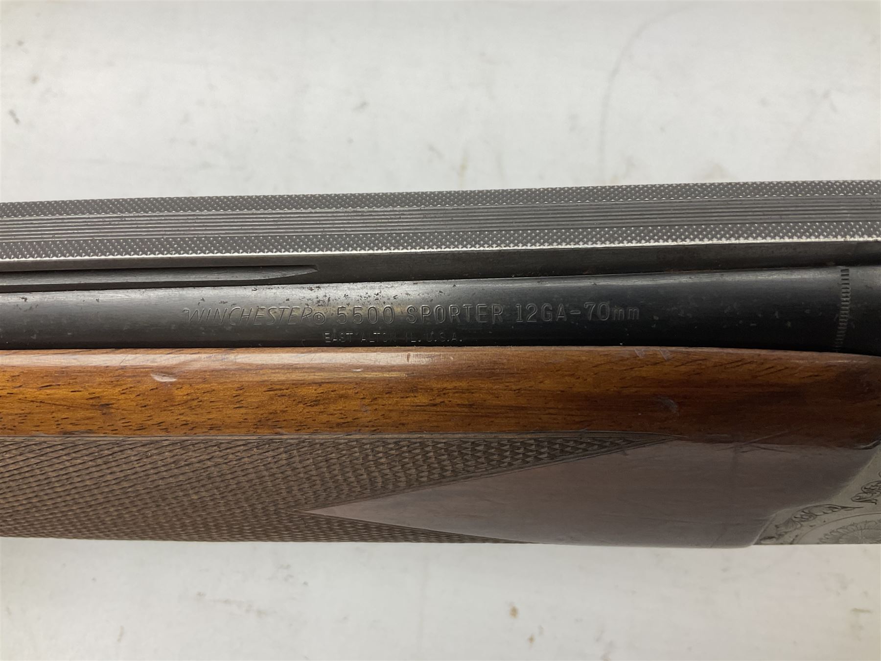 Winchester Japan 5500 12-bore by two-and-three quarters over-and-under double barrel boxlock ejector sporting gun, with 71cm barrels, ventilated rib and barrels, the walnut stock with chequered pistol grip and fore-end, single selective trigger and top safety, serial no.K542927E, L115cm overall; in gun sling SHOTGUN CERTIFICATE REQUIRED