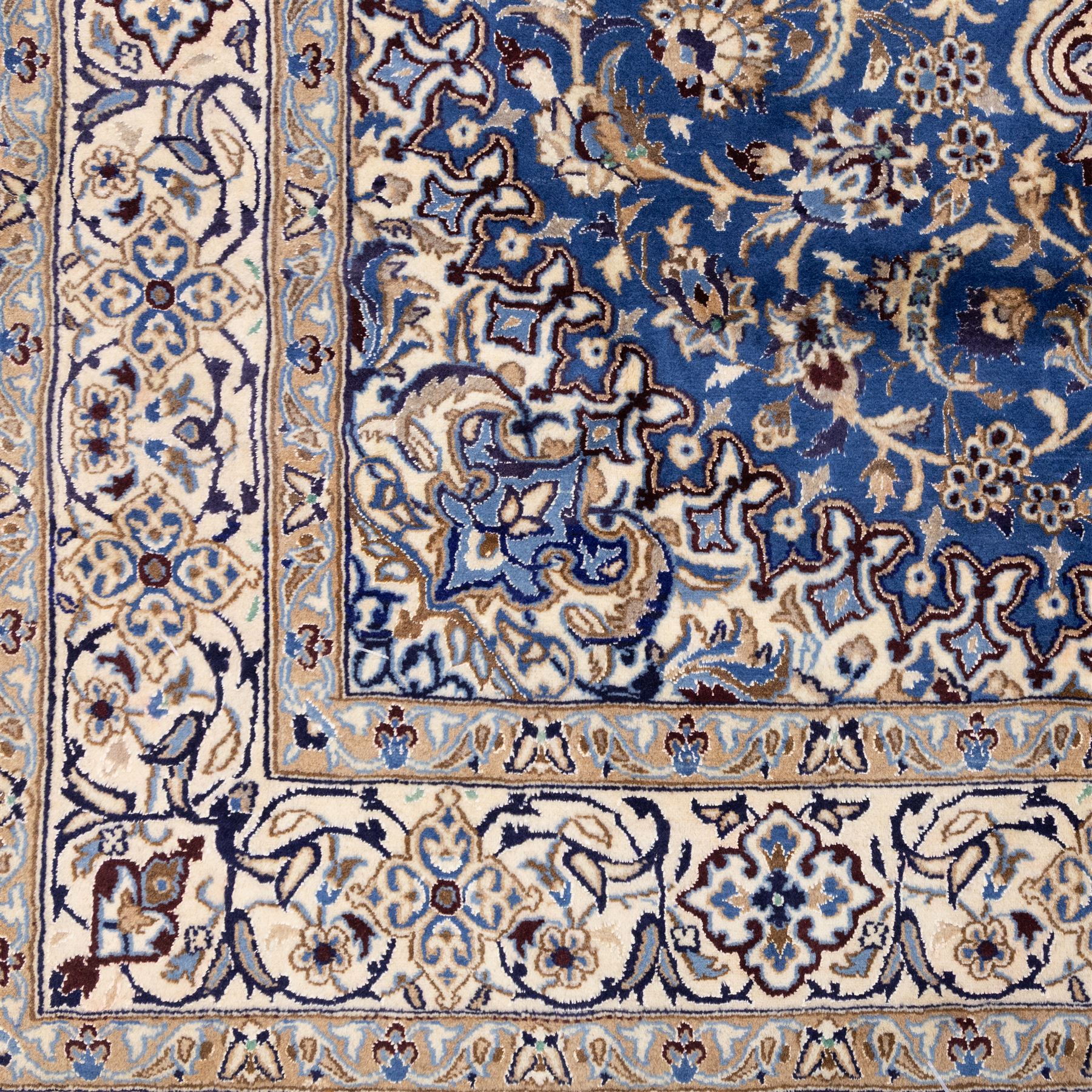 Central Persian Nain hand-knotted rug, soft blue field with central medallion with finely drawn scrolling palmettes and floral tendrils, with ivory spandrels, enclosed by a floral meander border flanked by multiple guard stripes with cotton fringe ends 