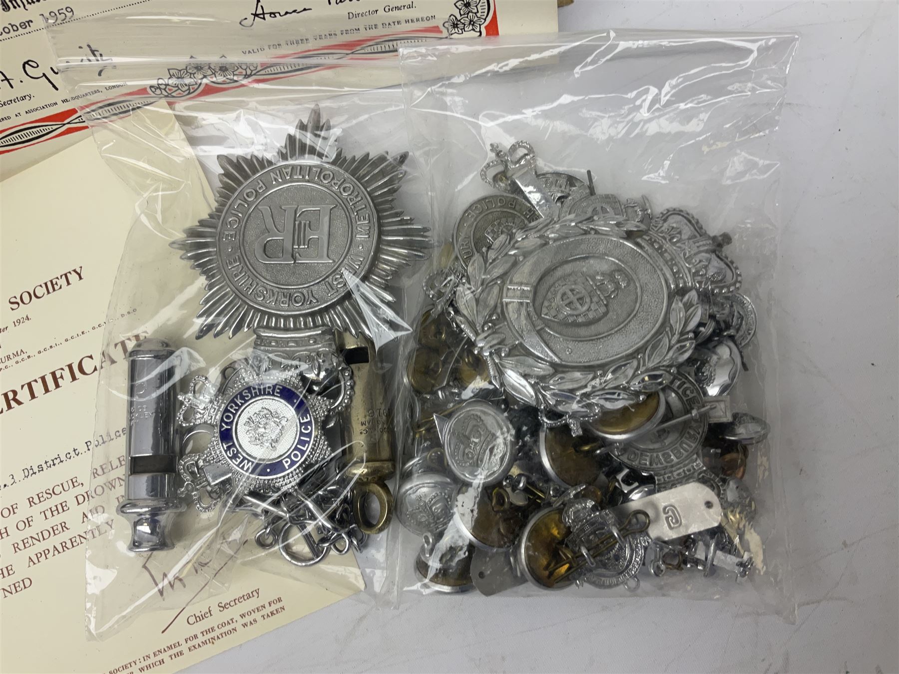 Archive of memorabilia and ephemera relating to Pc. (later Sgt.) Geoffrey Robinson of Dewsbury (later West Yorkshire) police force including cased Long Service and Good Conduct Medal; helmet plates and cap badges, collar numbers and uniform buttons, whistles, certificates, photographs, plaque etc 1960s - 1990s