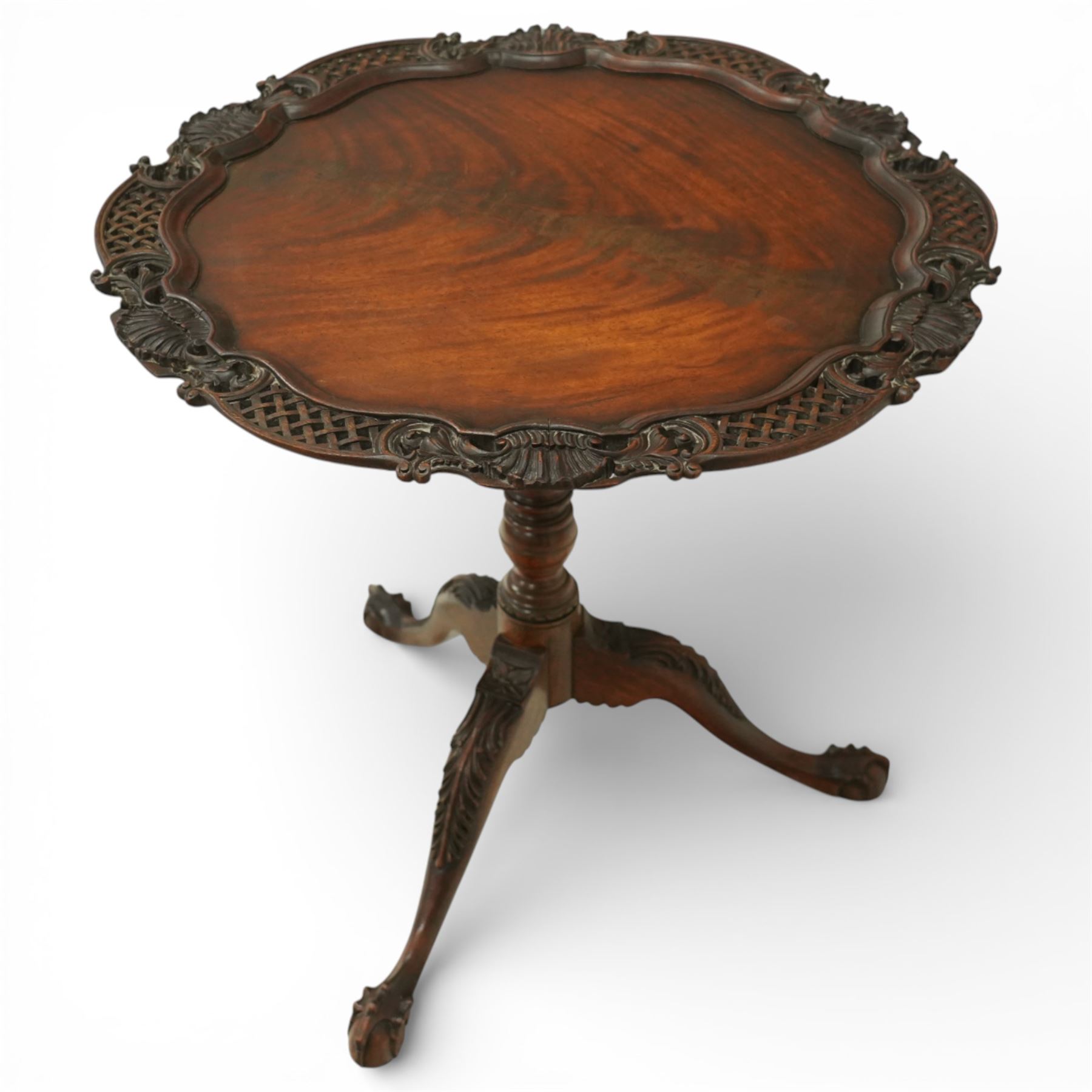 Late 19th century Rococo Revival mahogany occasional table, with shaped circular top with ornate lattice-pierced edge, decorated with pierced scallop motifs and acanthi, raised on a birdcage movement over turned pedestal, terminating to foliate-moulded tripod base with ball and claw feet