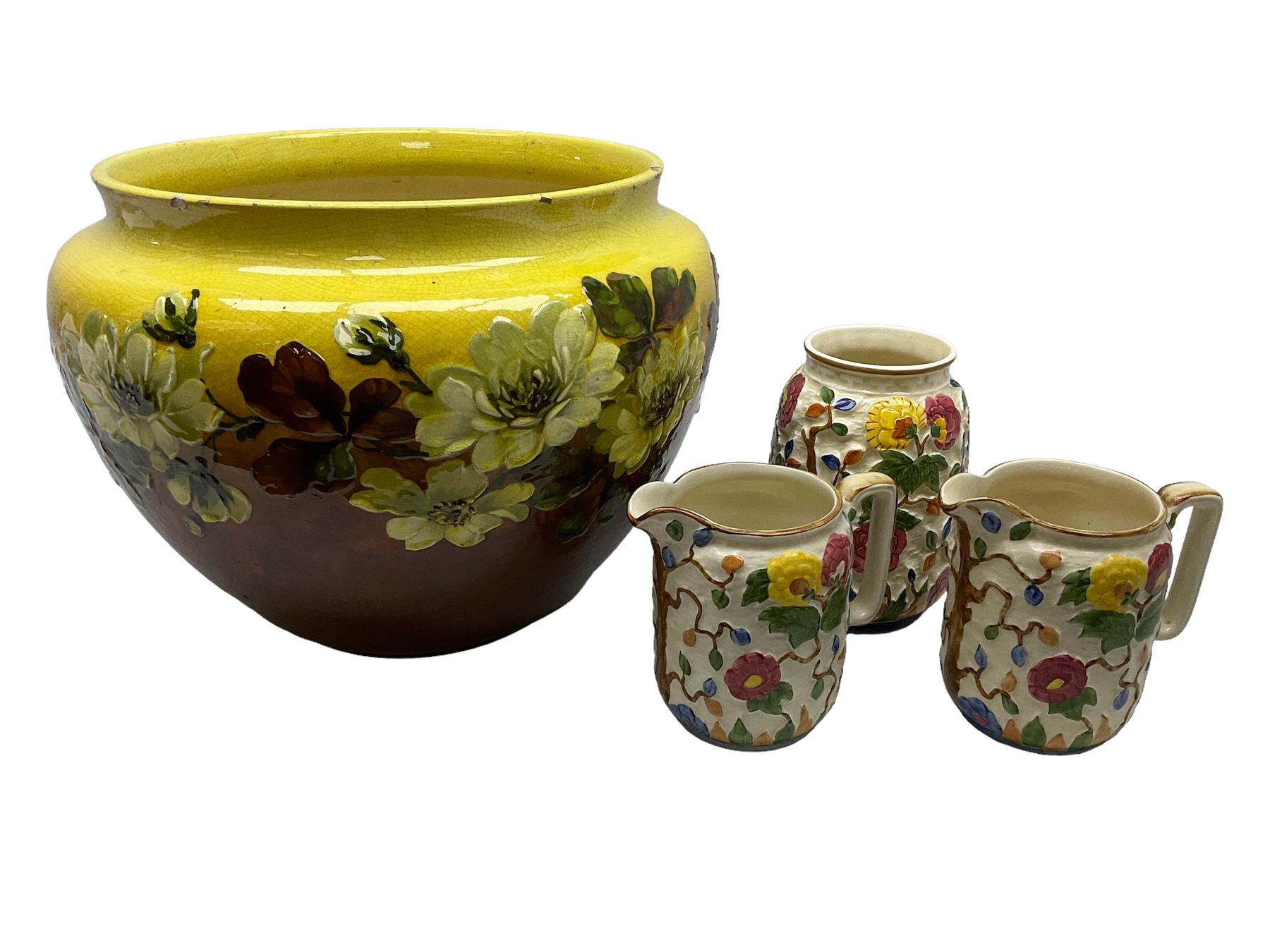 Victorian Leeds Art Pottery jardinière decorated with flowers and foliage on a brown and yellow merging ground, together with H.J. Wood Indian Tree jugs and vase, jardinière D37cm