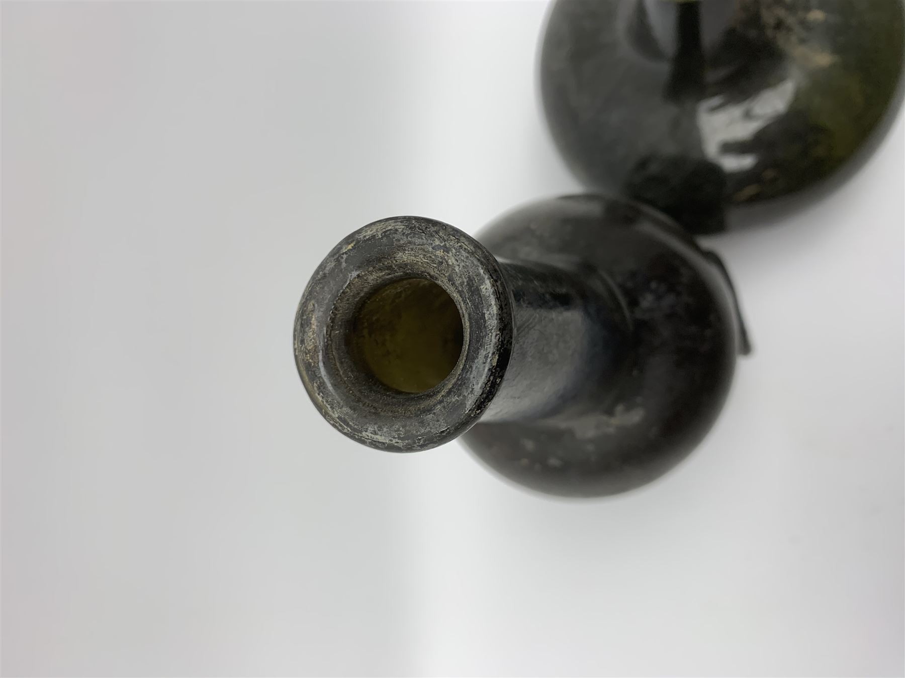 18th century green glass bottle, of onion form, H15cm, together with an 18th century green glass wine bottle, with seal depicting a boar beneath a crown, probably the Edgcumbe Crest, H27cm