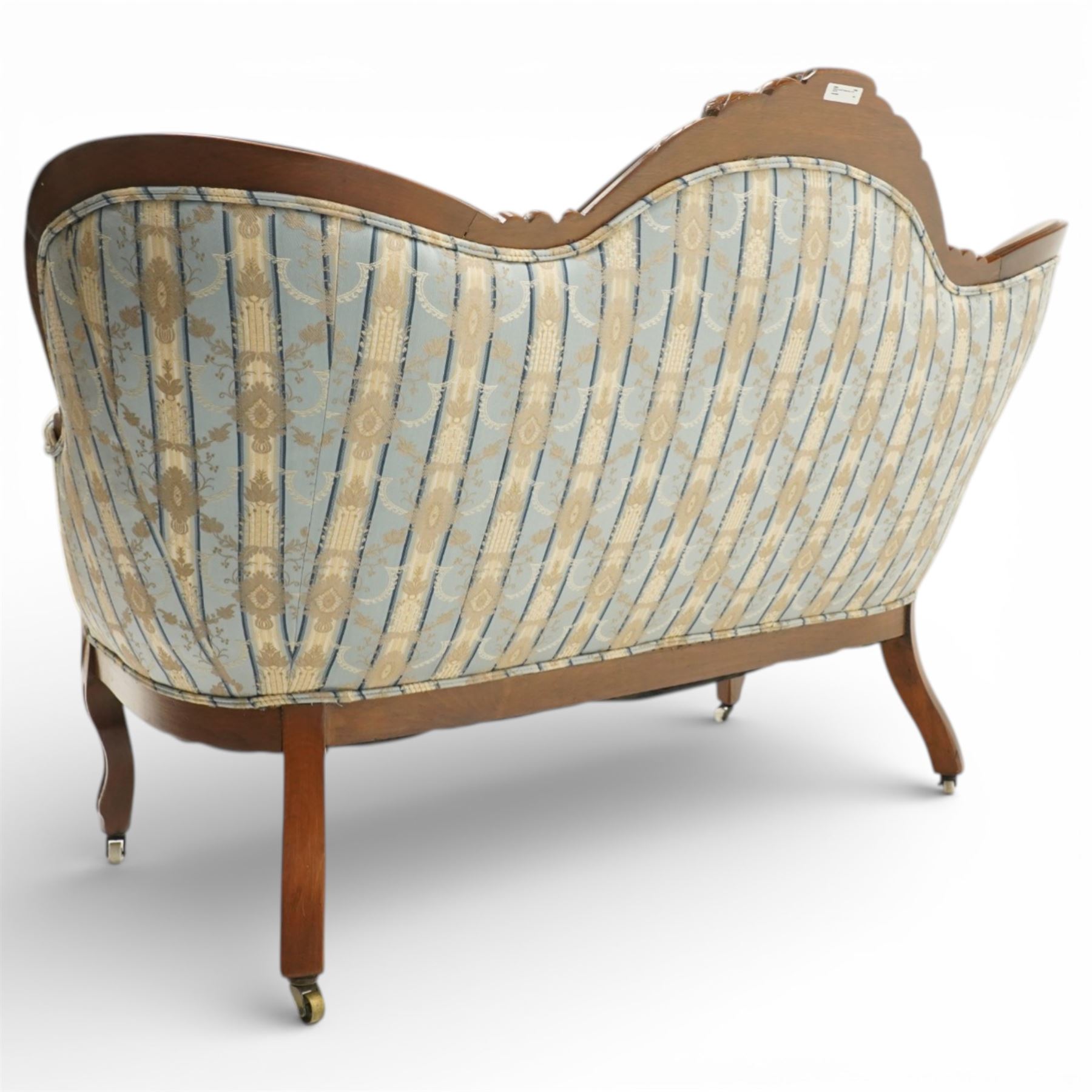 Victorian mahogany double cameo back sofa, the shaped back with central button upholstered oval panel and carved foliate crest above upholstered arms and seat, raised on cabriole legs terminating in castors