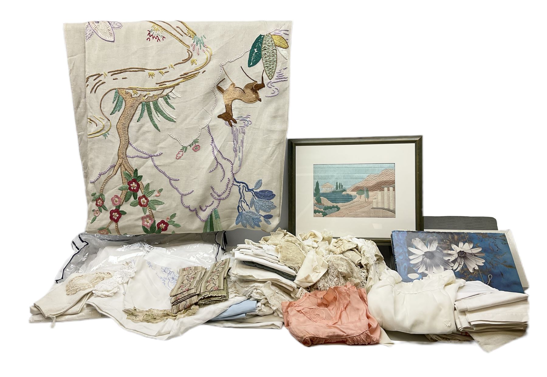 Large quantity of table linen and Victorian and later lace, framed machine tapestry depicting Greece, embroidered wall hanging decorated with a woodland scene with deer and blossoming tree, embroidered linen decorated with floral design, crochet, etc