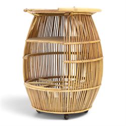 Italian mid-20th century barrel-shaped bar cart in rattan and bamboo, the circular top with rattan and bamboo handle, above a rattan shelf with bamboo bottle dividers below, raised on castors