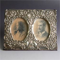 Late Victorian silver double photograph frame, embossed with flowers, scrolls and leaves, ...