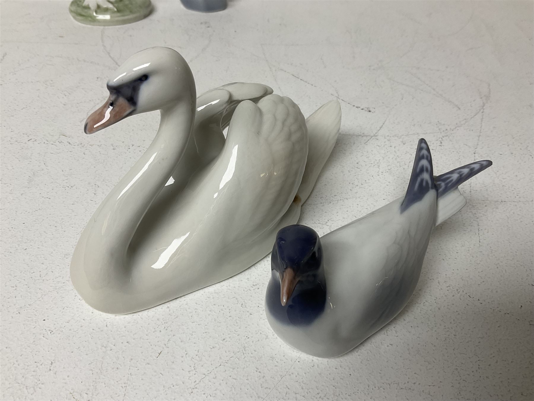 Seven Royal Copenhagen figures, including Arctic tern no 827, Swan no 755, Kingfisher no 2257 etc, together with Royal Copenhagen dish