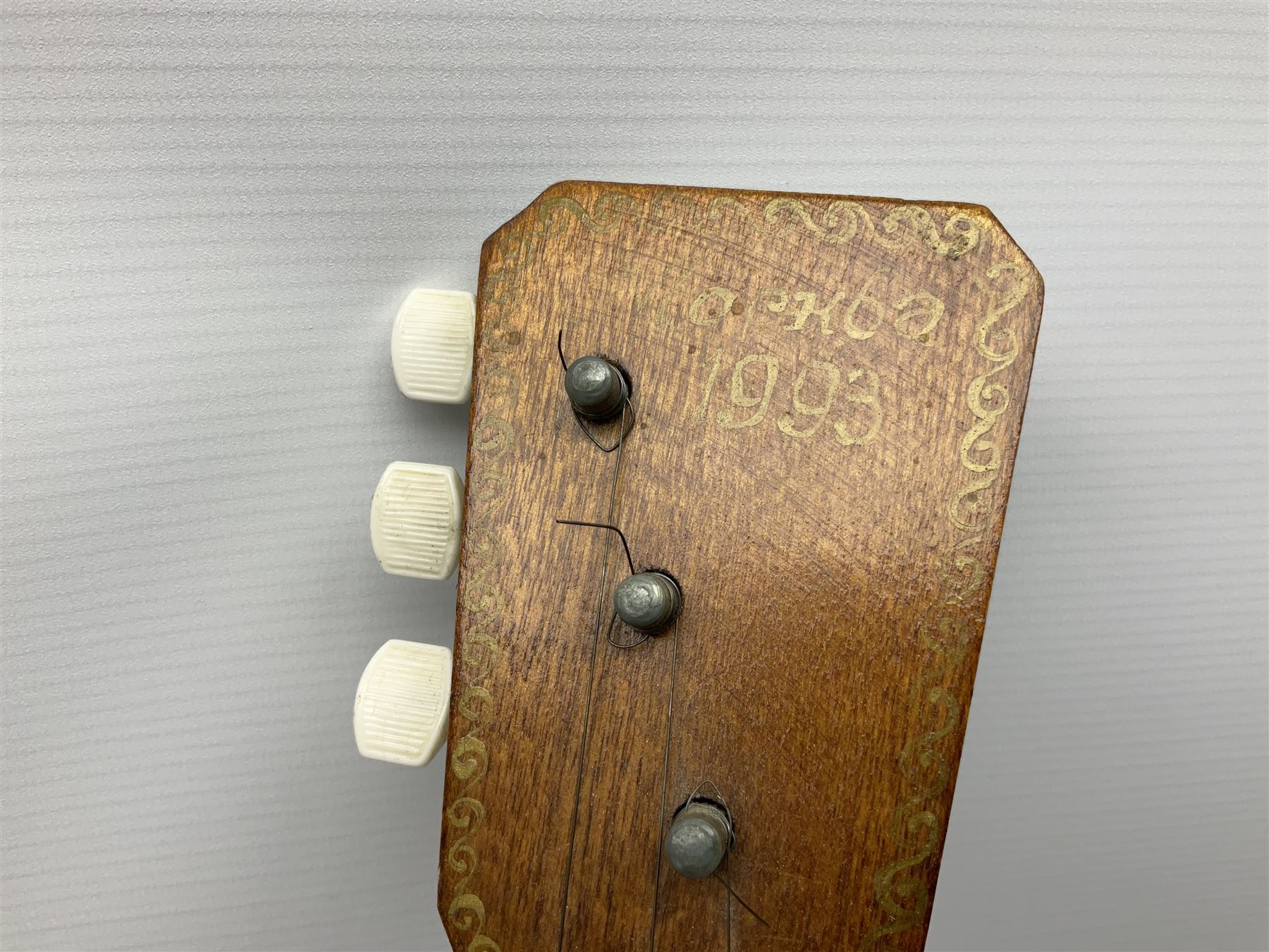 Russian balalaika with six-piece segmented back, the top painted with a scene of Russian onion capped buildings monogrammed K.B.H.1993; bears cyrillic label; L67.5cm; in carrying bag