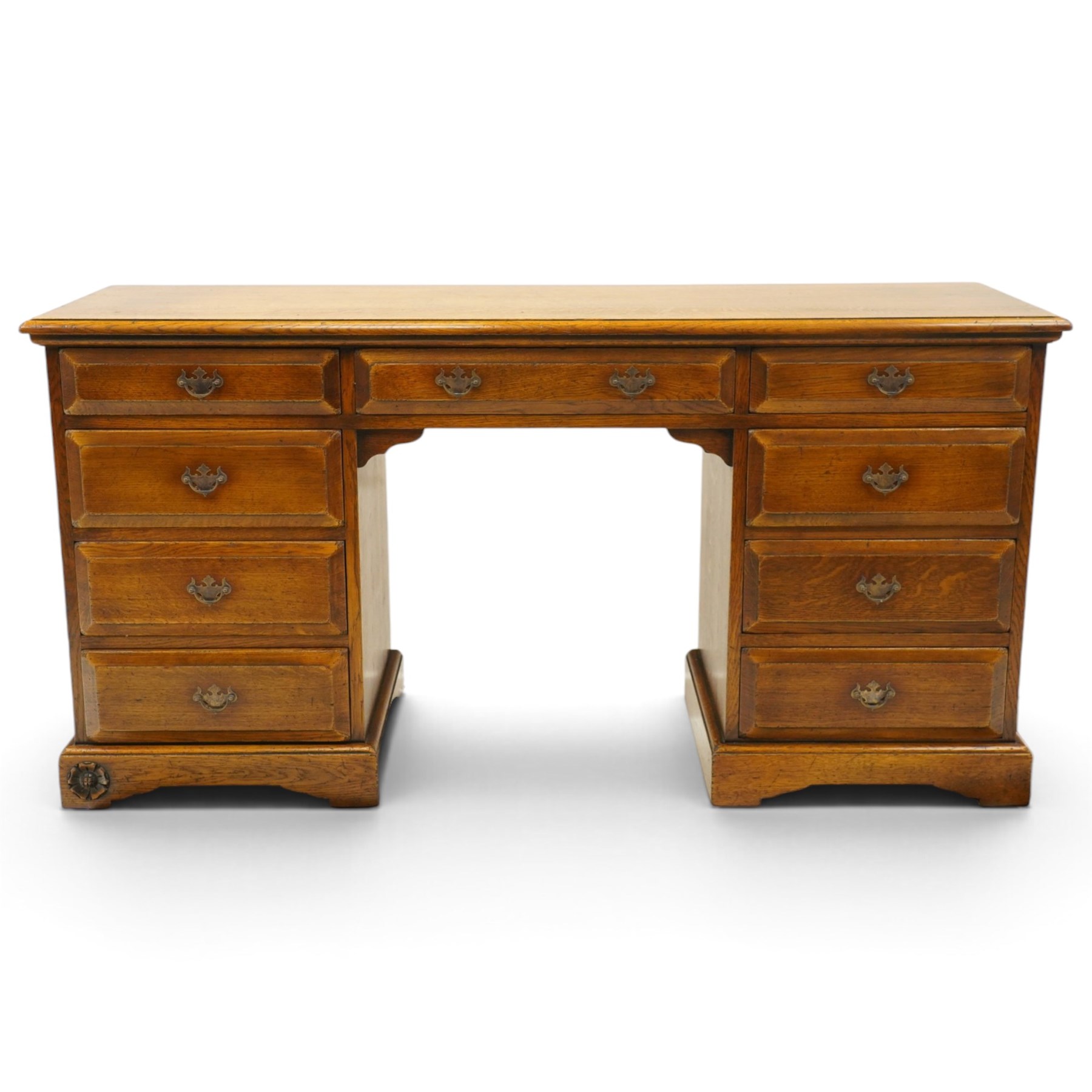 Royal Oak Furniture Company Of Grassington - Georgian design oak kneehole desk, rectangular top with moulded edge, fitted with central frieze drawer flanked by eight graduating drawers, raised on skirted base
