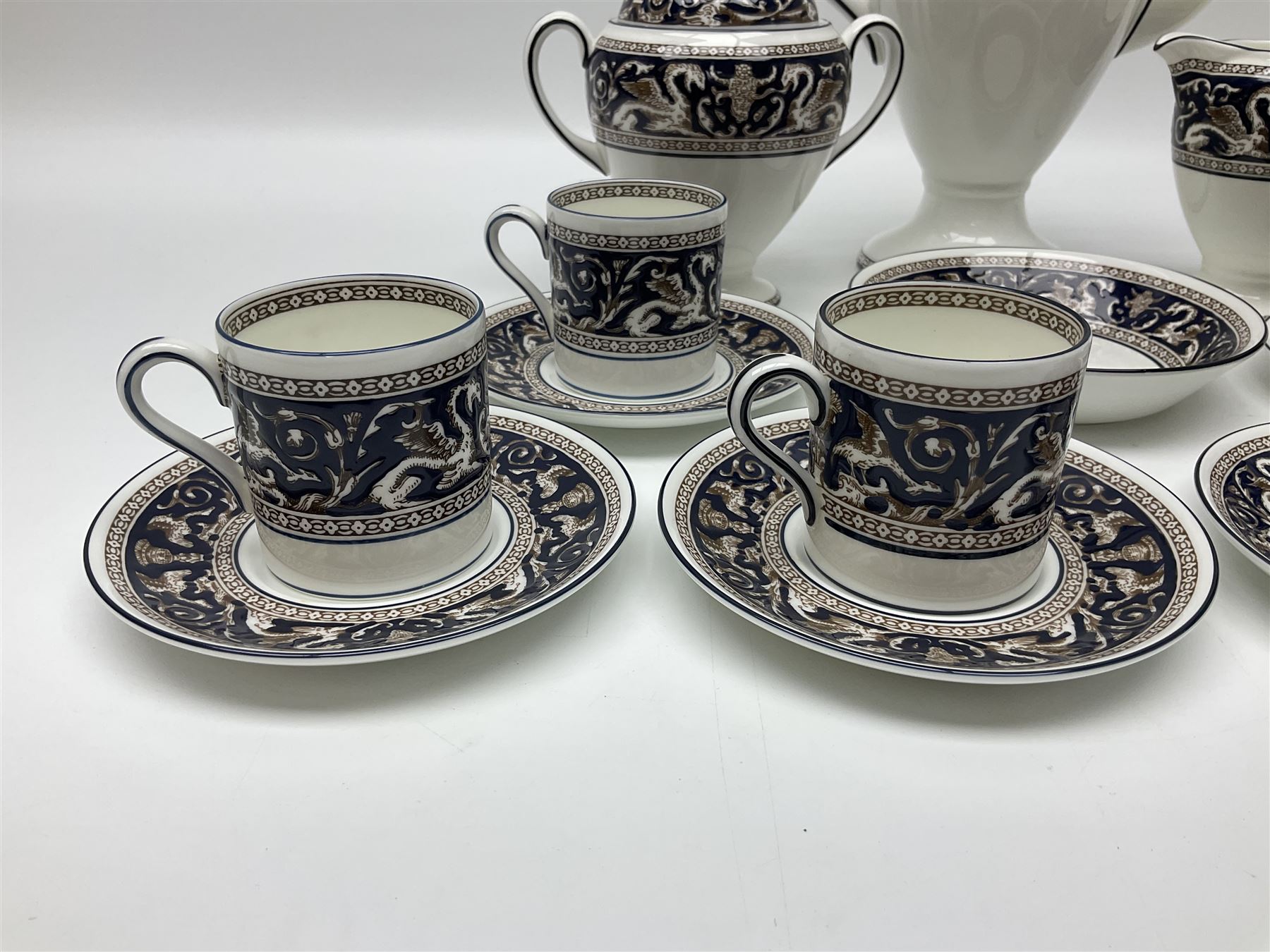 Wedgwood navy Florentine pattern coffee service for six, comprising coffeepot, coffee cans and saucers, milk jug, twin handled covered sucrier and small dish