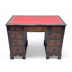 Georgian design mahogany kneehole desk, moulded rectangular top with red gilt-tooled leather writing surface, over an arrangement of nine cock-beaded drawers with brass swan neck handles, on bracket feet