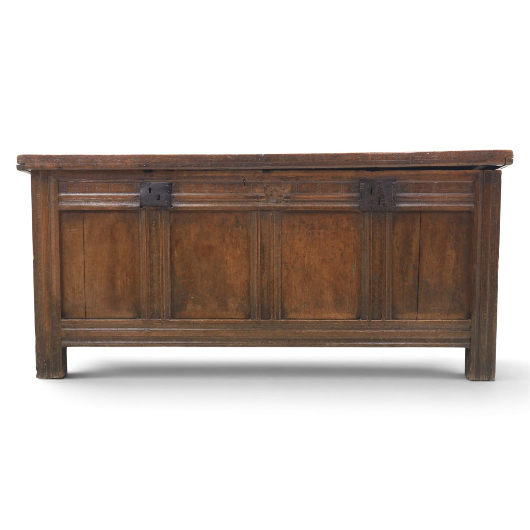 Large 17th century oak coffer, plank top with moulded edge, four panel front with channel moulded uprights, retaining original wrought iron strap hinges and central lock plate, panelled ends, raised on stile supports