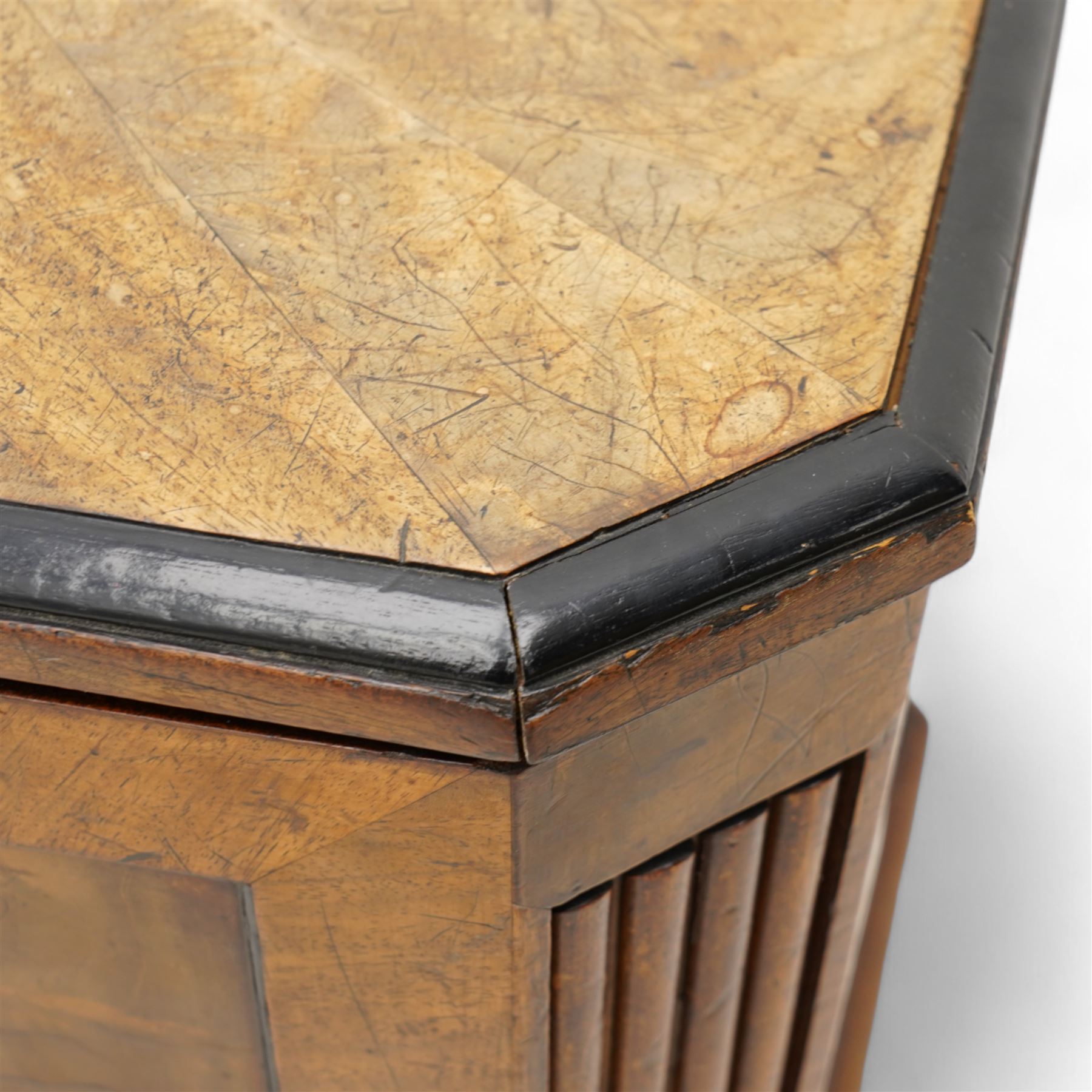 Early 19th century mahogany cellarette, tapering canted rectangular form, the hinged faceted top enclosing fitted interior, panelled front, back and sides with figured mahogany veneers, the canted corner with wide reeded decoration, on canted bracket feet 