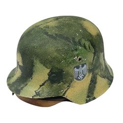 Fully restored German steel helmet, the camouflage painted exterior with two decals and replacement leather liner
