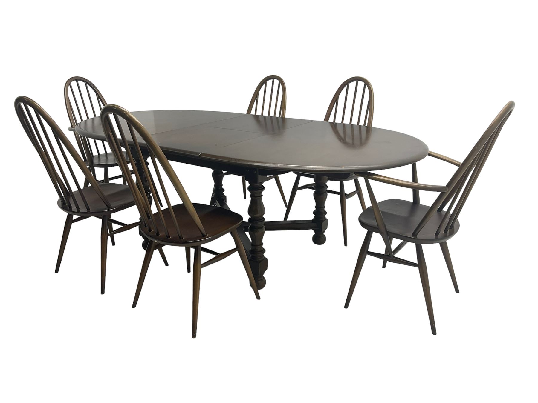 Ercol - 'Old Colonial' 705 elm extending dining table, oval top with hidden leaf, raised on turned supports united by X-stretcher (W163cm D108cm H72cm); and Ercol - set six  (4+2) dark elm 'Quaker Back Windsor Dining Chairs', hoop and stick backs 
