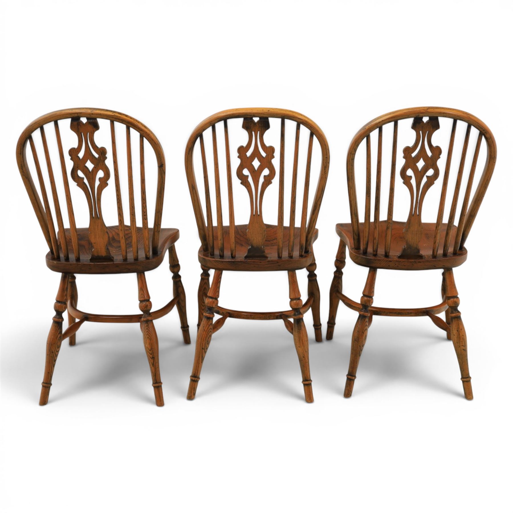 Set of six elm Windsor chairs, saddle seats with crinoline stretchers