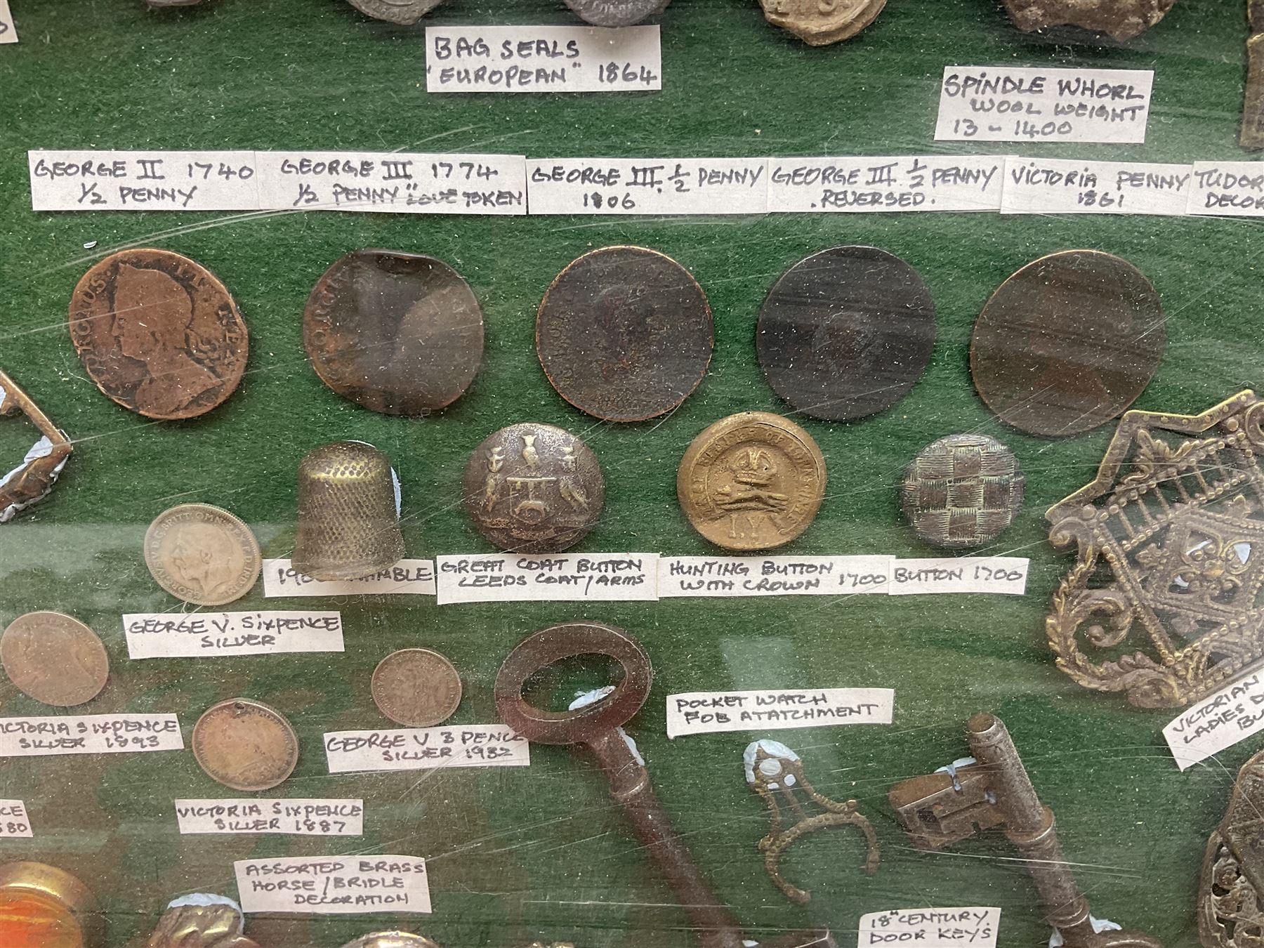 Collection of metal detecting finds and antiquities, housed on five display boards and some loose, to include coins, keys, axe head etc 