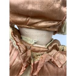 German bisque head doll with applied hair, sleeping eyes and open mouth with teeth and fixed tongue, on composition body with jointed limbs, marked 'P.M. 914 Germany 14' H65cm