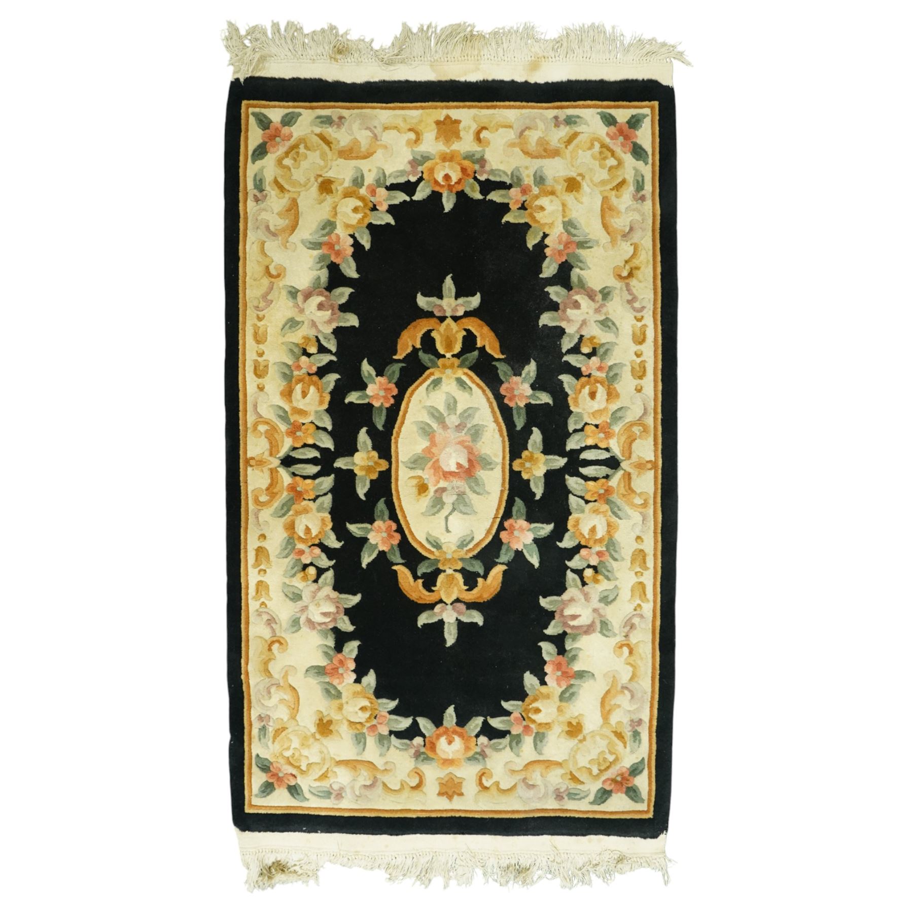 Chinese Aubusson design wool rug, black field with a central oval floral medallion framed by a wide border of scrolling flowers and foliage in soft pastel tones, with ivory spandrels and cotton fringe ends 