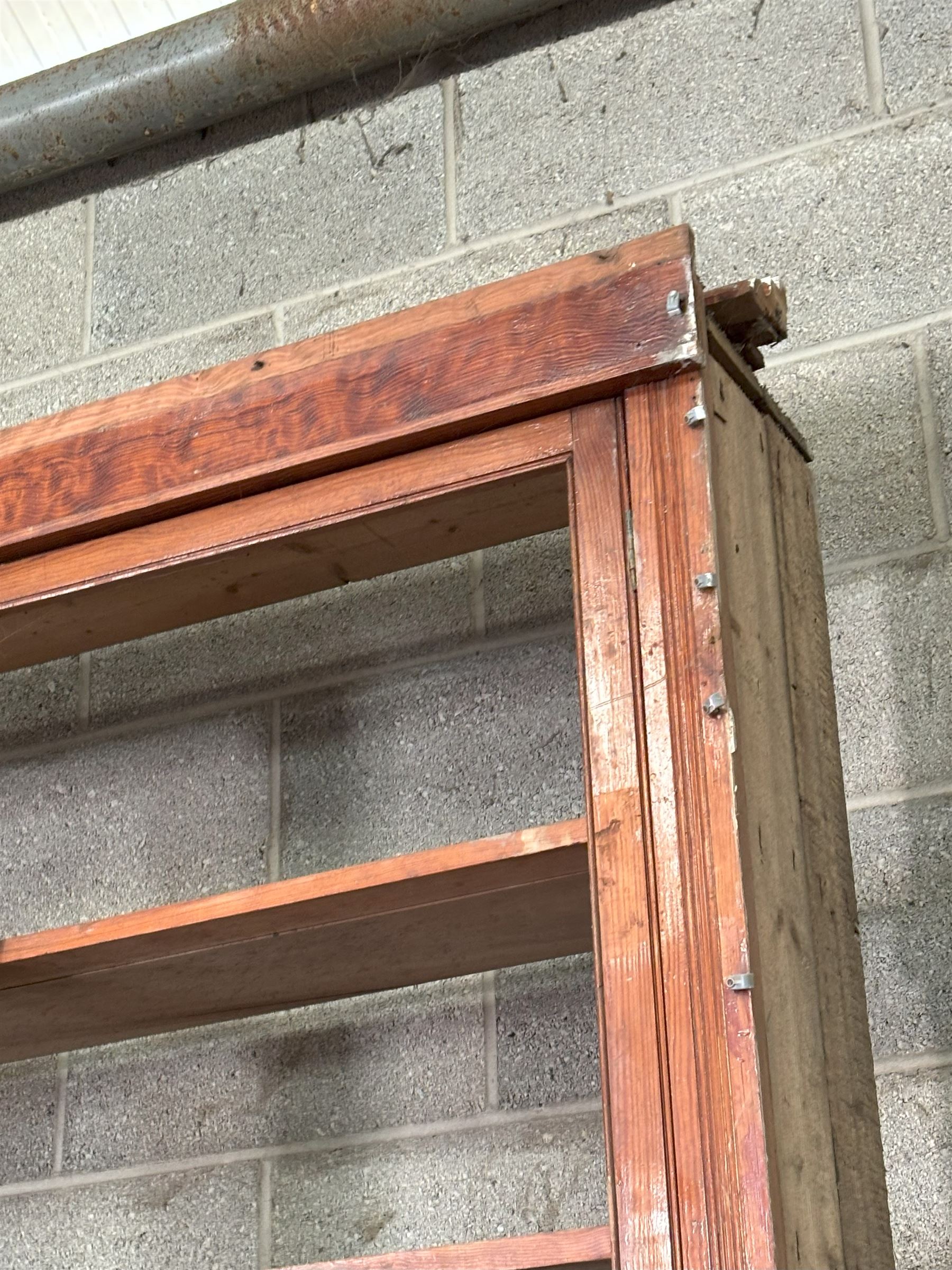 Large pitch pine library bookcase, early 20th century, the top fitted with six doors enclosing six shelves, above six panelled doors to base, for restoration. Splits in four for transportation.  H285cm, L426cm, D49cm - COLLECTION BY APPOINTMENT FROM: The White House, Thirsk Road, Easingwold, York, YO61 3NF - CALL 01723 507111 TO ARRANGE