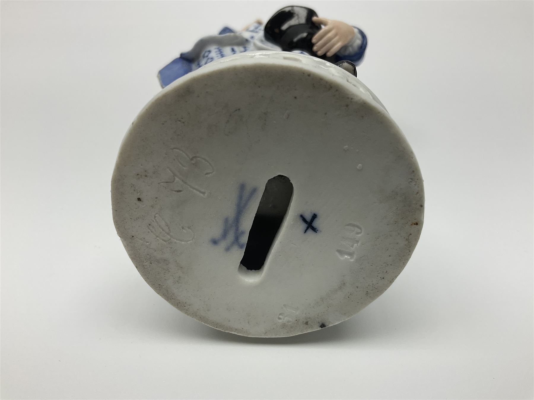 Meissen blue and white figure, modelled as a gentleman holding a hat of flowers, raised upon Greek key design base, with blue crossed swords and impressed C 73 and 149 marks beneath, H18cm