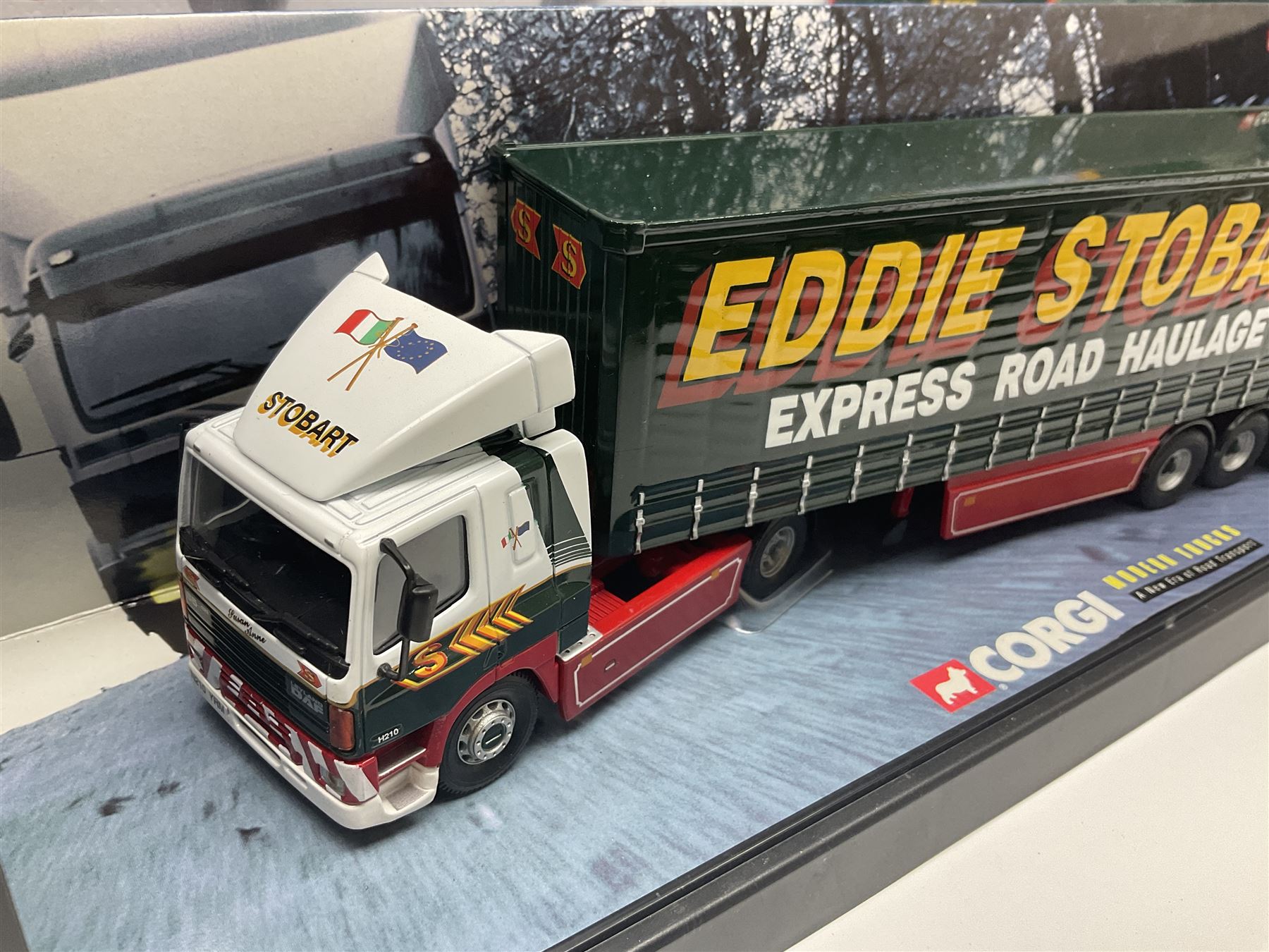 Corgi Eddie Stobart - four heavy haulage vehicles comprising 75201 ERF Curtainside; 75403 Leyland-DAF Curtainside; both in plastic display boxes; CC12610 Scammell Crusader 3 Axle Low Loader; and CC12502 Atkinson Borderer Flatbed Trailer; together with AA30008 Douglas DC-3 Aircraft; all boxed (5)