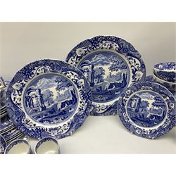Spode blue and white Italian pattern dinner and tea wares, comprising five dinner plates, four side plates, seventeen side plates, four bowls, ten tea cups and twenty one saucers, five coffee cans and six saucers, and a flan dish, with blue and black printed marks beneath 