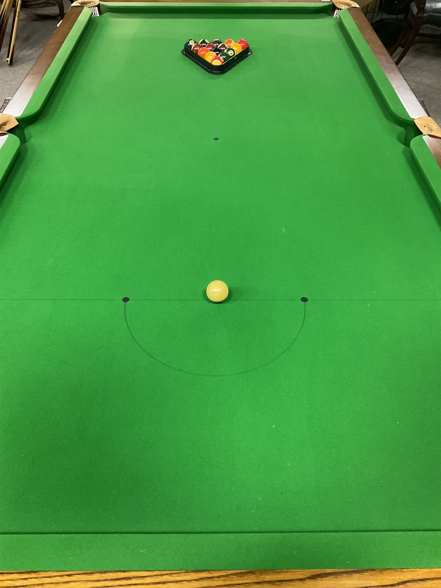 Late 20th century oak slate bed billiard table, on six turned column supports,  together with cues, ball set, baize brush, triangles and scoreboard 