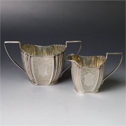 Late Victorian silver twin handled open sucrier and milk jug, of fluted form with panels of engraved foliate decoration, hallmarked D & M Davis, London 1896
