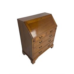 Georgian design mahogany bureau, fall-front enclosing fitted interior with satinwood strung drawers, above two short and three long drawers, on bracket feet