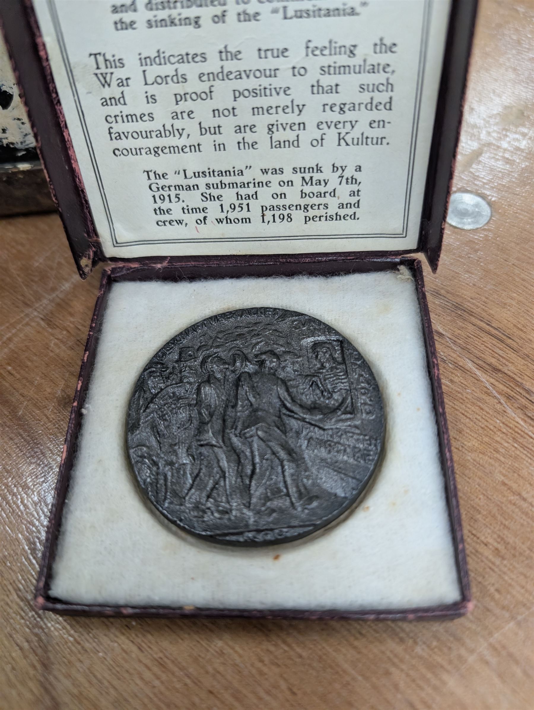 WWI brass shell case, by vendor repute salvaged from SS Cadmus wreckage site June 2007 off Flamborough Head, together with a reproduction RMS Lusitania medal in box and a metal tin