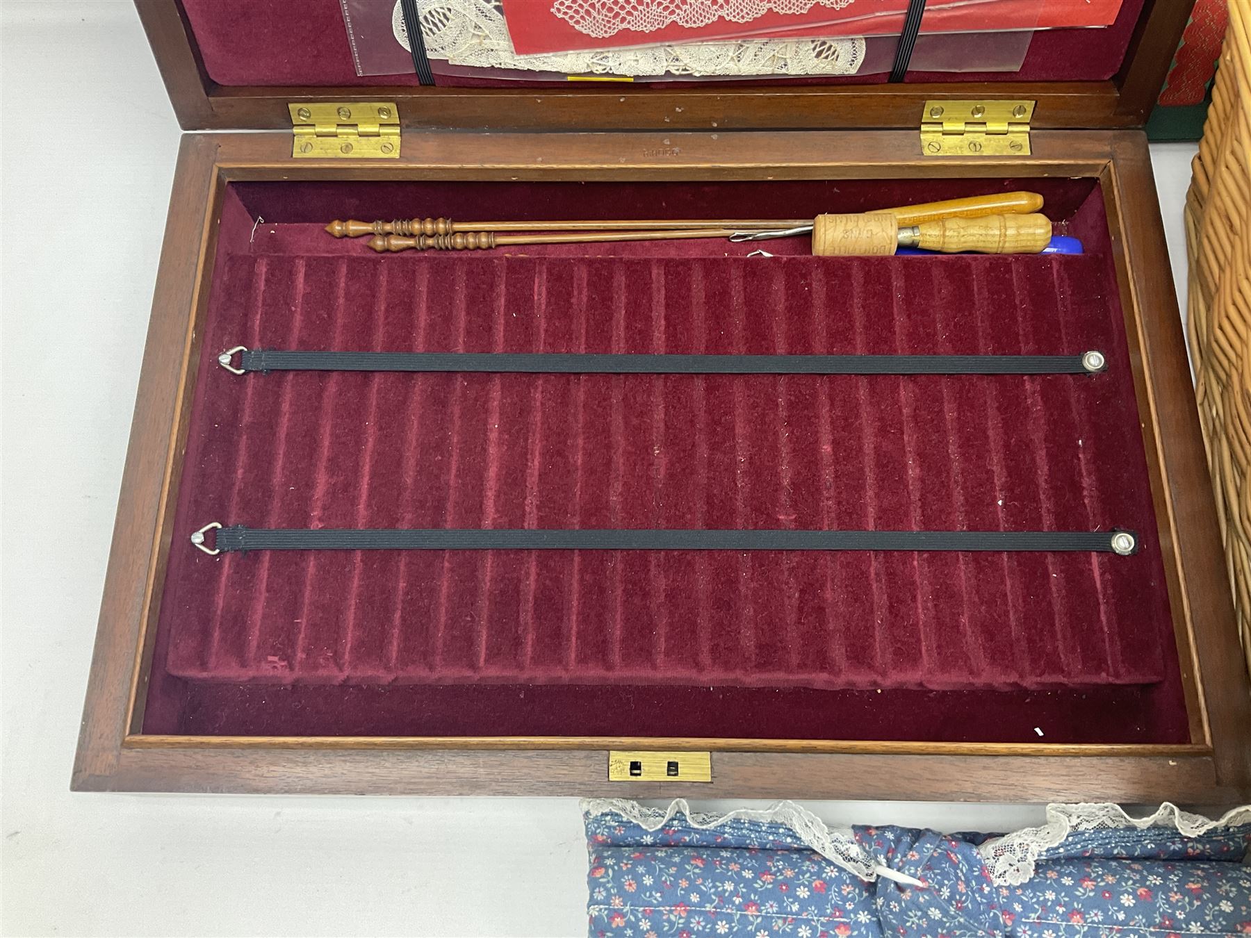 Collection of lace making wooden bobbins, together with lace making books and a handmade storage box