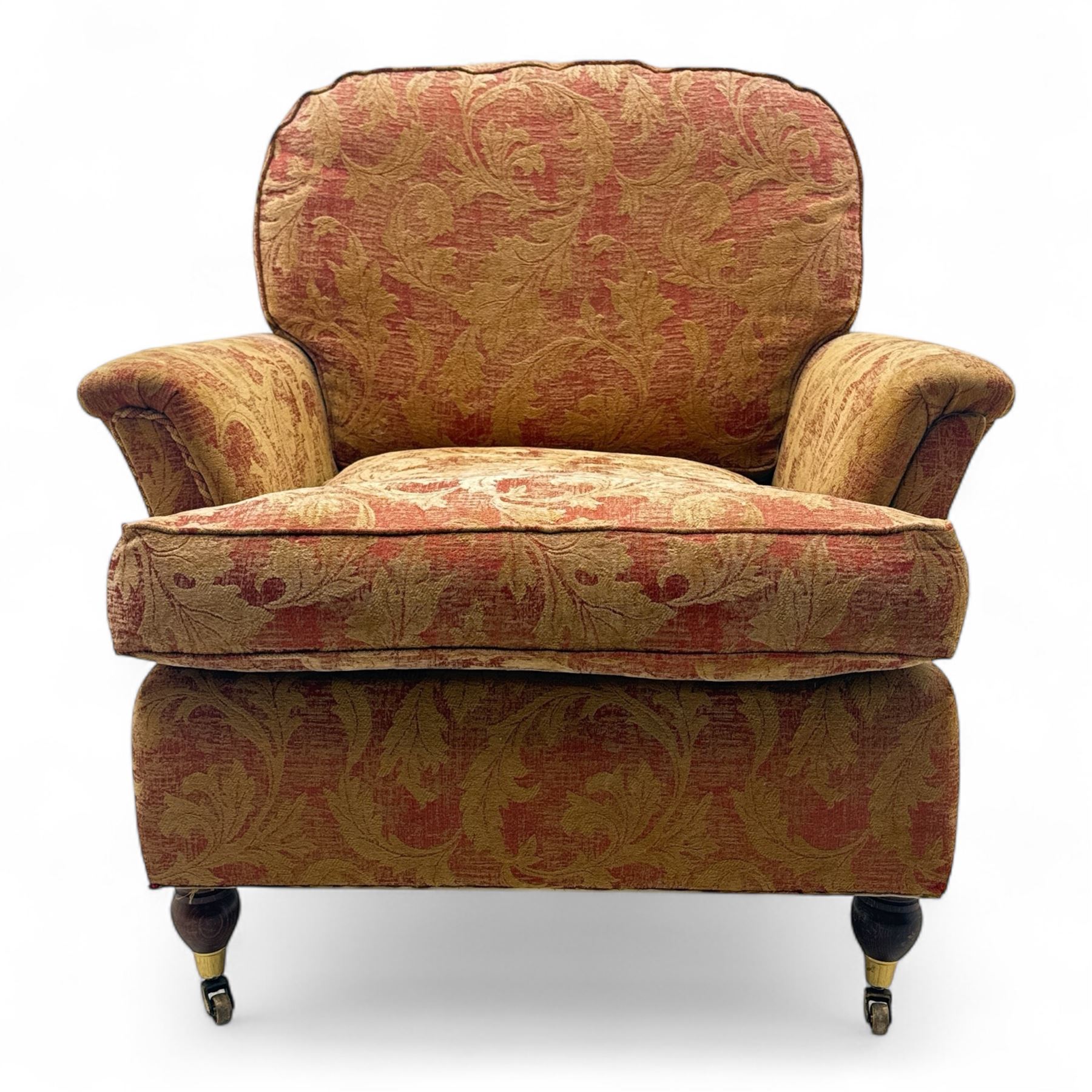 Duresta - Contemporary pair of upholstered armchairs, in red and gold damask style fabric, each with sprung seat and removable cushion back, rolled arms, on turned front supports with brass castors, square back legs 