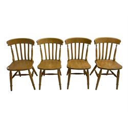 Set of four beech farmhouse design dining chairs, shaped bar back over vertical slats, on turned supports united by H stretchers 