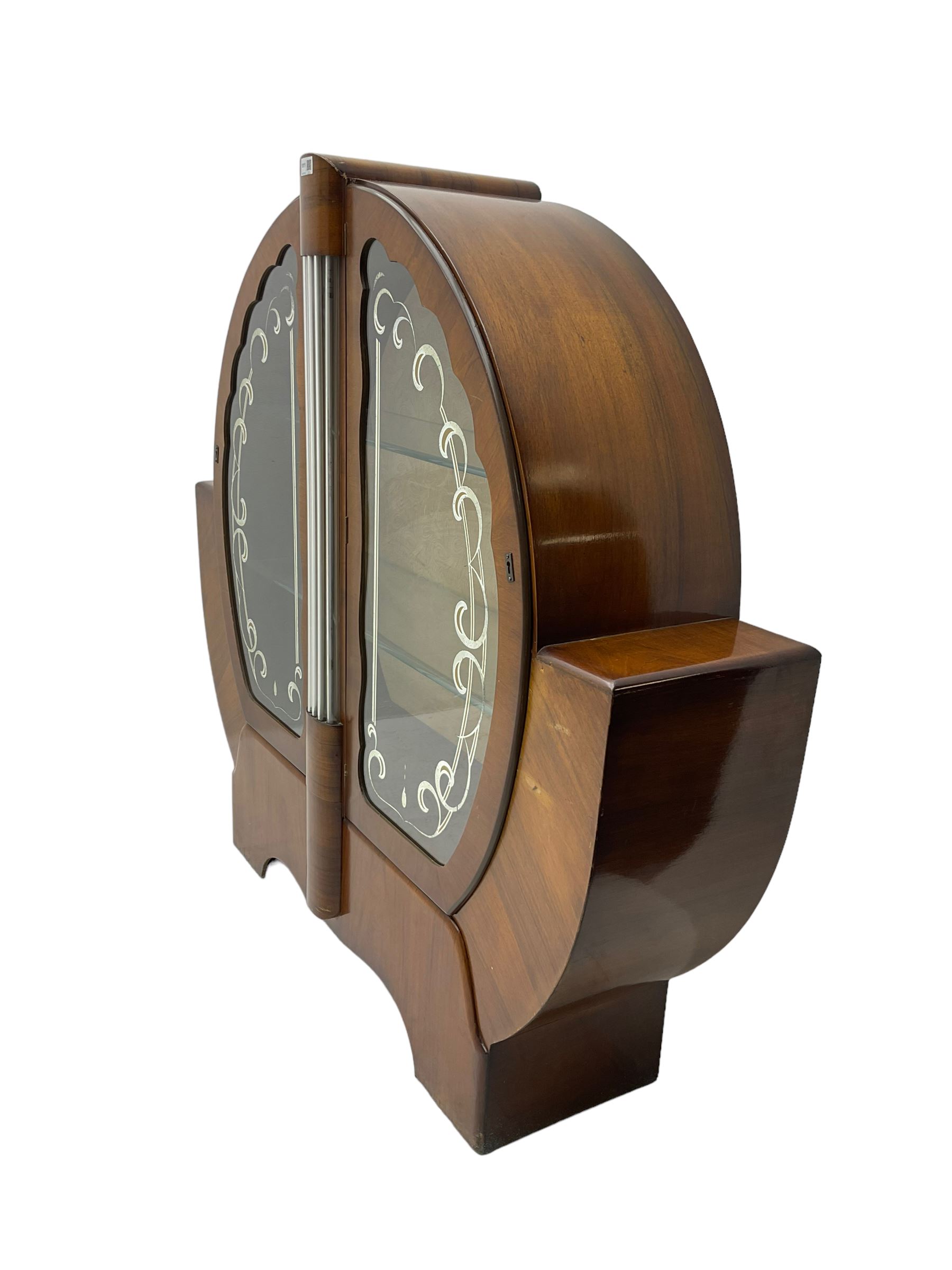 Art Deco walnut display cabinet, of circular design, fitted with two shaped glazed doors enclosing two glass shelves, flanking five glass rods