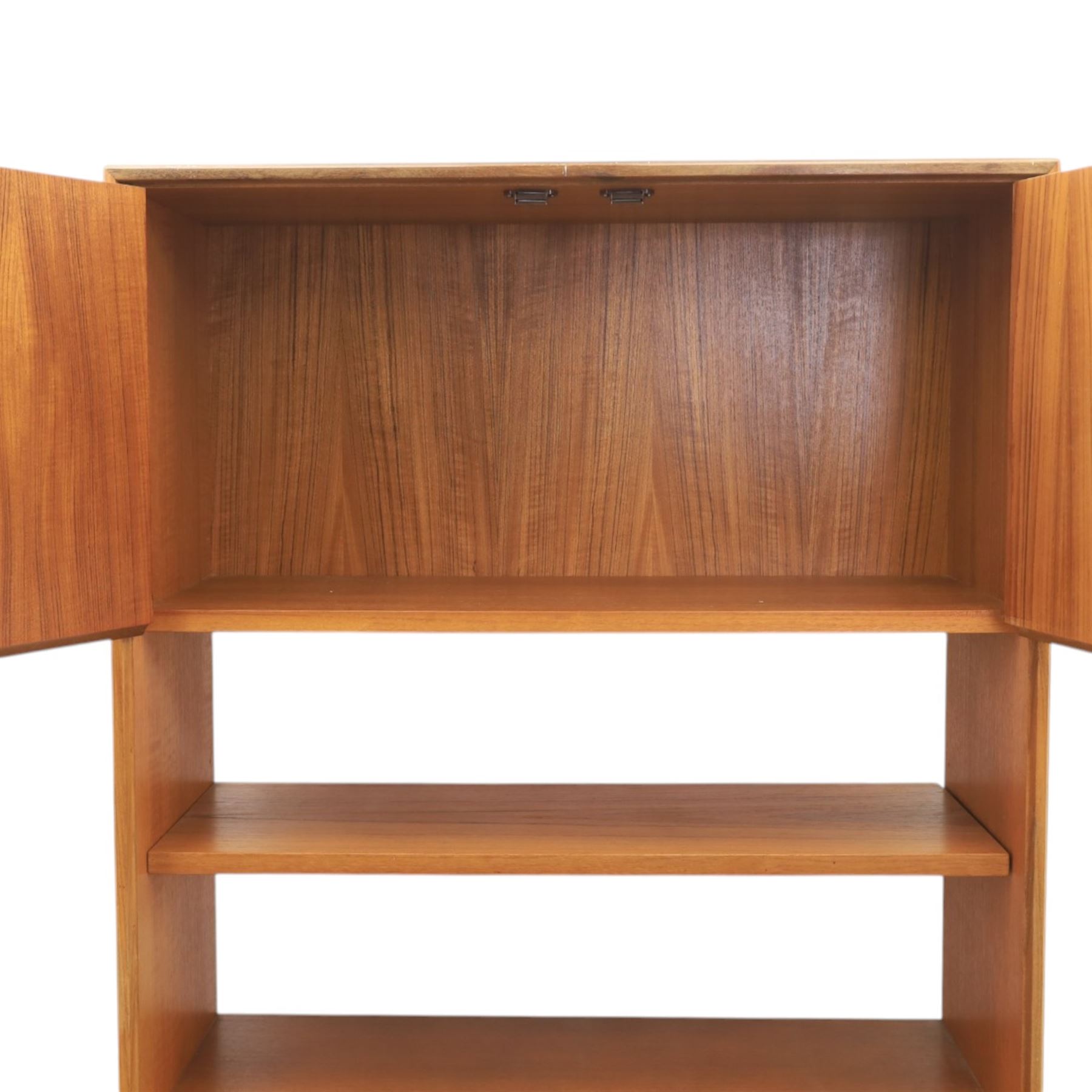 G Plan - Mid 20th century teak units, comprising tall shelving unit with cupboard sections, fall front and open shelves, together with a low twin-door cupboard unit, on plinth bases

Low unit: H 53cm, D 46cm, W 81cm
Tall unit: H 199cm, D 46cm, W 76cm